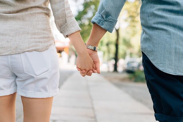 A man without sexual performance issues holds a woman's hand